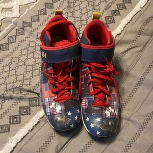 Under Armour Kids baseball cleats in Red and Blue